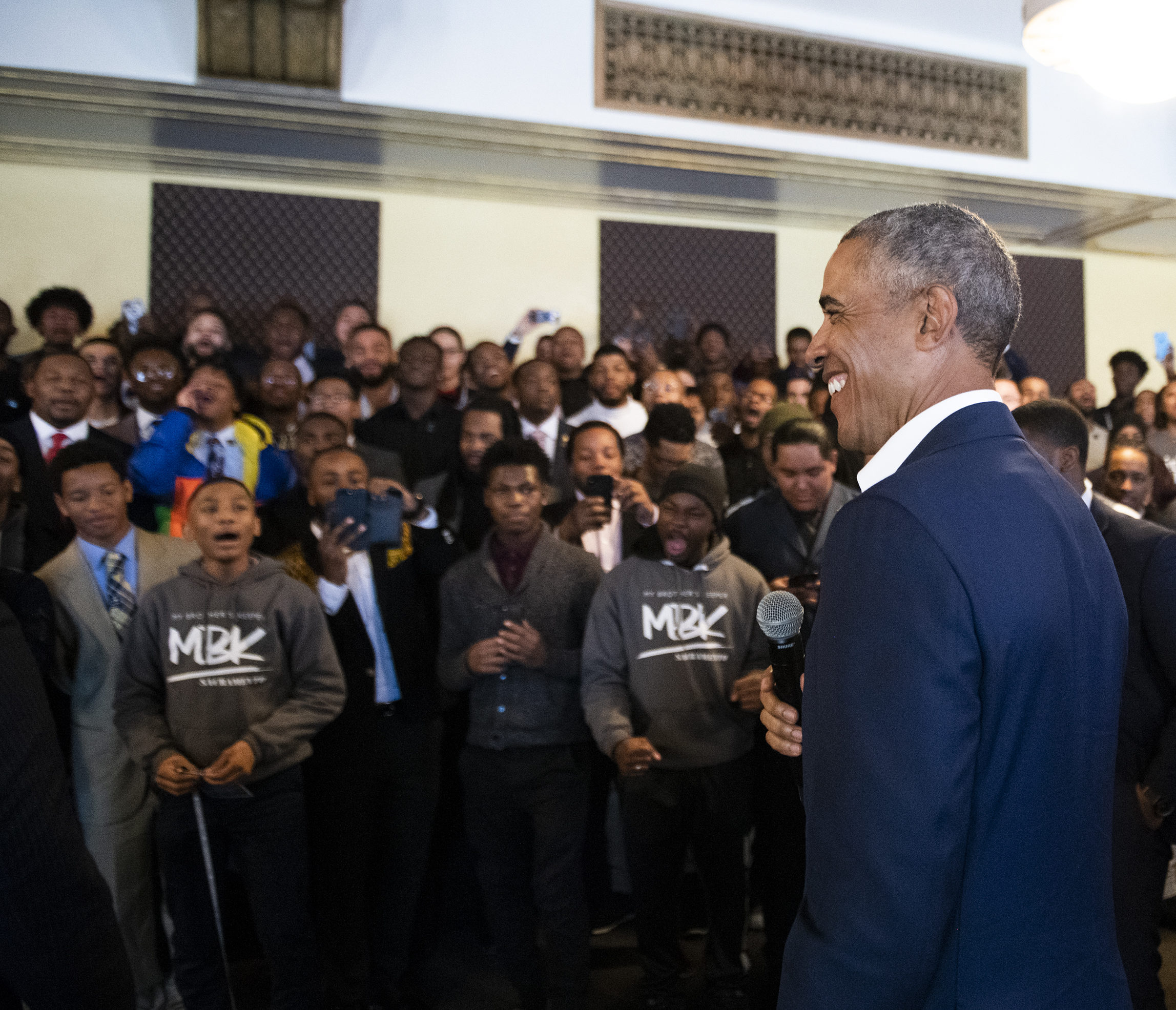 President Obama speaks to a group of young men of various skin tones