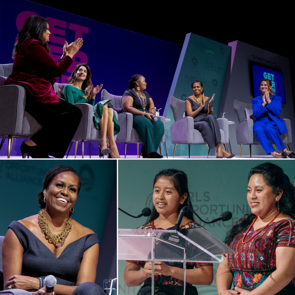 A three-photo collage. The photo on the top is of First Lady Michelle Obama wearing a heather black jumpsuit and brown heels sitting amongst four other women of different skin tones as they all sit in gray chairs. In the background is a three-layer wall with one layer being royal blue with purple writing, the second layer being teal with the Obama Foundation logo, and the third layer being gray with a screen attached. The photo on the bottom left is a portrait photo of First Lady Michelle Obama wearing a heather black jumpsuit and smiling in front of a teal background. The photo on the bottom right is of two ladies with light-medium skin tones wearing patterned dresses and standing behind a clear podium in front of a teal background. 