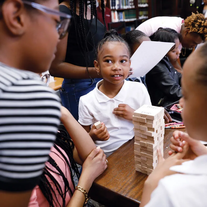 Children play Jenga at the Obama Youth Jobs Corps announcement ceremony.
