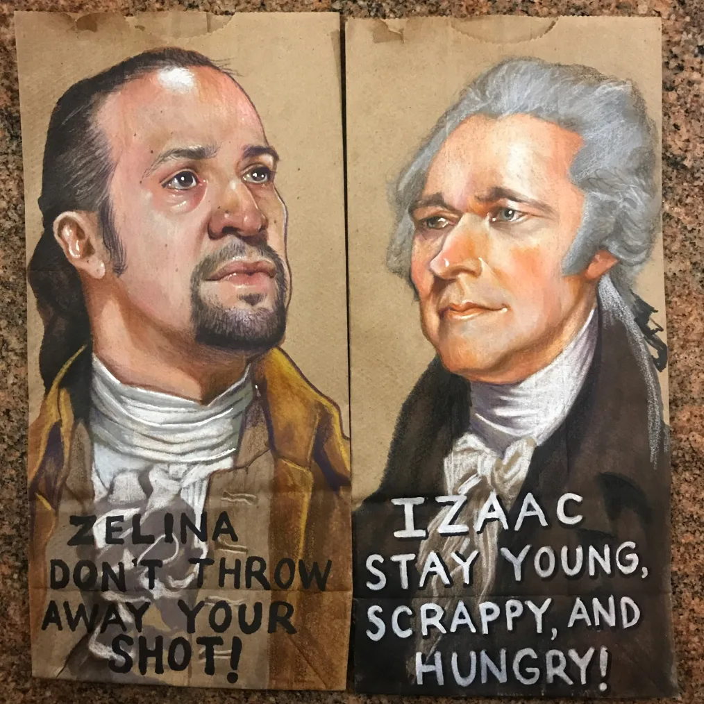 A painting on a brown paper bag of a man looking into the distance with a medium skin tone and long black hair put up in a ponytail with text at the bottom. Beside it, is another painting on a brown paper bag of an older man with grayish-white and light skin tone with text underneath also 