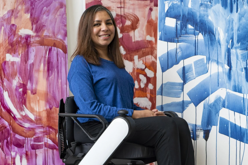 Pooja in front of her large-scale paintings