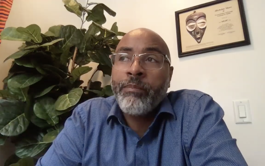 Dr. Donald Tyler sits in an office, wearing a blue shirt.