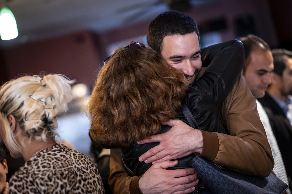 Members of the Obama Scholars New York and Chicago cohorts hug during a welcome dinner at Garifuna Flava in Chicago, IL.