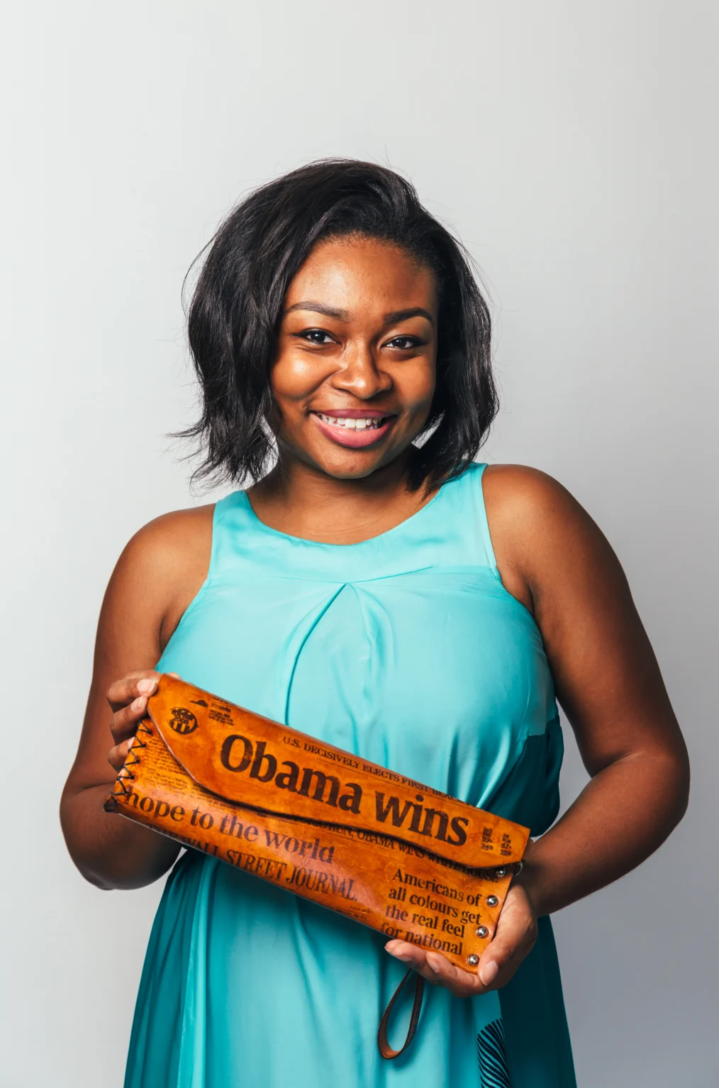 Pier Smith holds her Obama clutch and smiles to camera.