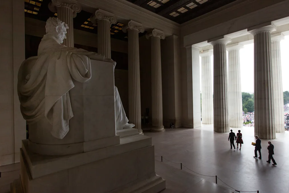 The silhouettes of President Obama, First Lady Michelle Obama, and former Presidents Bill Clinton and Jimmy Carter walk past the statue of President Lincoln to participate in the ceremony on the 50th anniversary of the historic March on Washington for Jobs and Freedom and Dr. Martin Luther King, Jr.'s "I Have a Dream" speech, at the Lincoln Memorial in Washington, D.C.