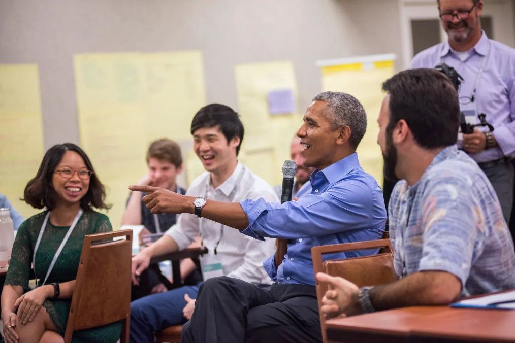 President Obama smiles and points during a leadership training session.