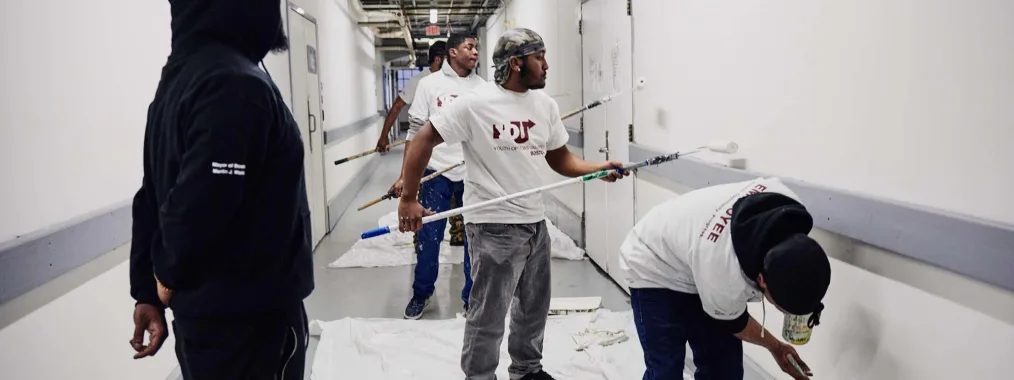 mass mentoring volunteers painting hallway