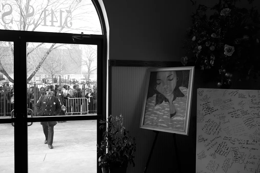 In a black and white photo, First Lady Michelle Obama, Sec of Education Arne Duncan, Valerie Jarrett, Mayor Rahm Emanuel attend Hadiya Pendleton funeral services at Greater Harvest Missionary Baptist Church in Chicago, IL Feb 10, 2013. (Official White House Photo by Chuck Kennedy)