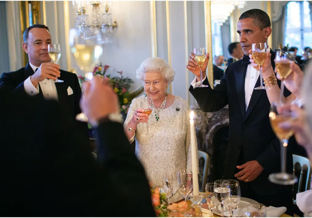 This picture shows President Obama and Queen Elizabeth II making a toast holding wine glasses
in the air.