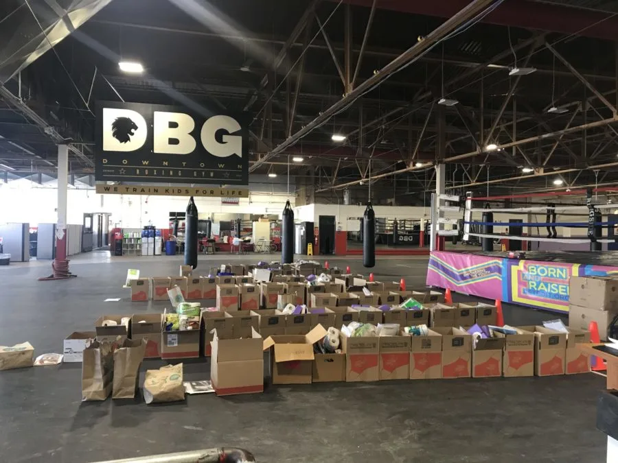 This is the Downtown Boxing Gym, normally packed with students, instead filled with boxes that contain meals, supplies and academic packets to be delivered to students and their families.