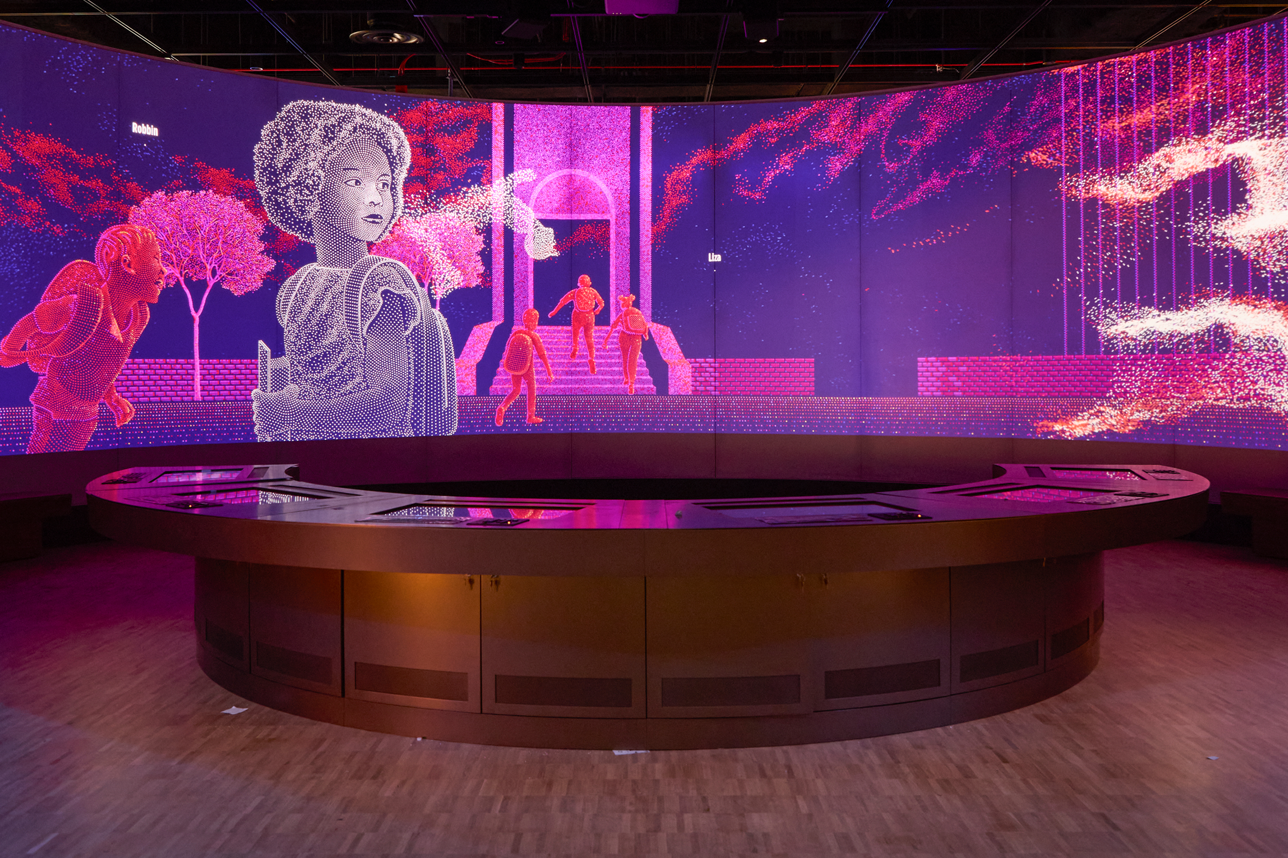 An image of one of the digital screens in the “We The People” exhibit. The image is dotted with bright hues of pink and purple. There is an illustrated woman in the forefront of the picture, looking off into the distance. In the background of the screen are several faceless people walking into a building Below the screen is an interactive panel for visitors to the Museum to use. 