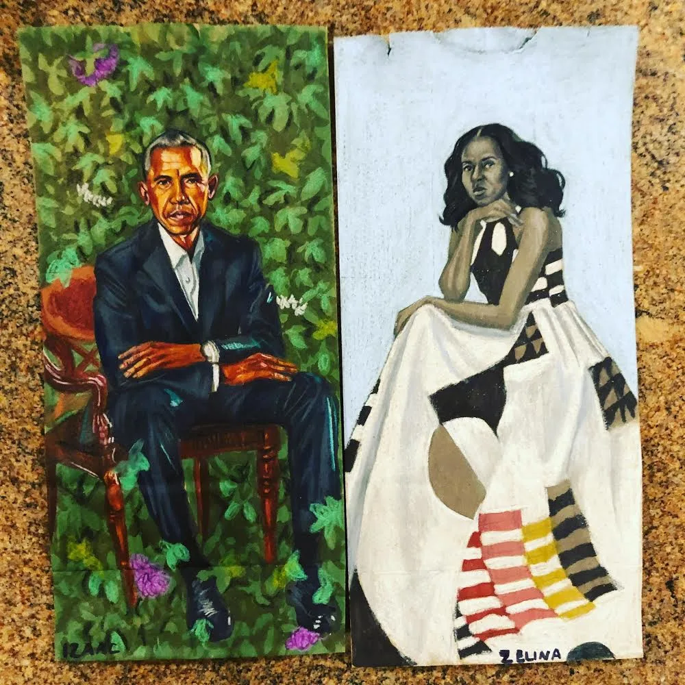 A painting on a brown paper bag of President Obama wearing a suit as he sits in a brown chair and behind him are leaves and flowers. Beside it is a painting on a brown bag of a First Lady, Michelle Obama in a long white dress.