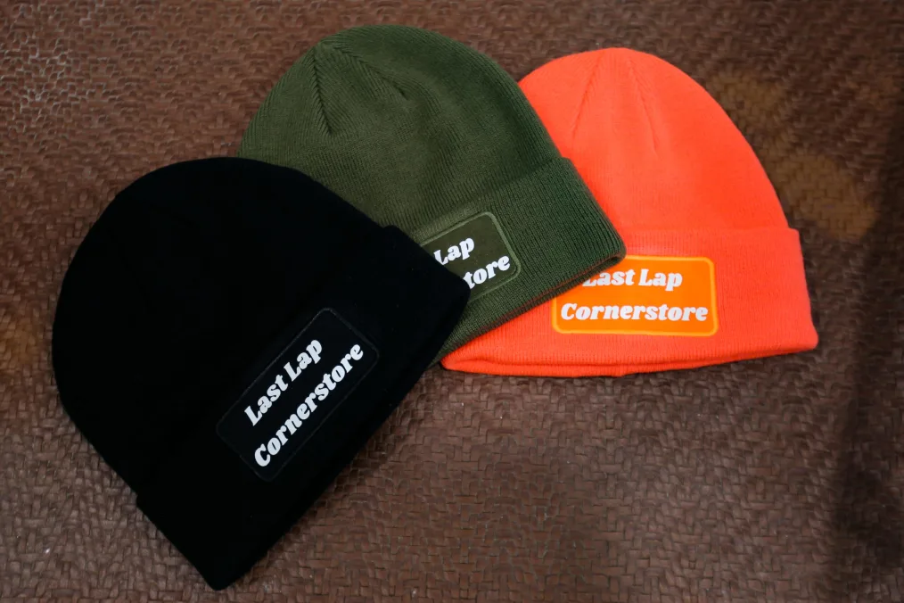 An assortment of Last Lap Cornerstore beanies.