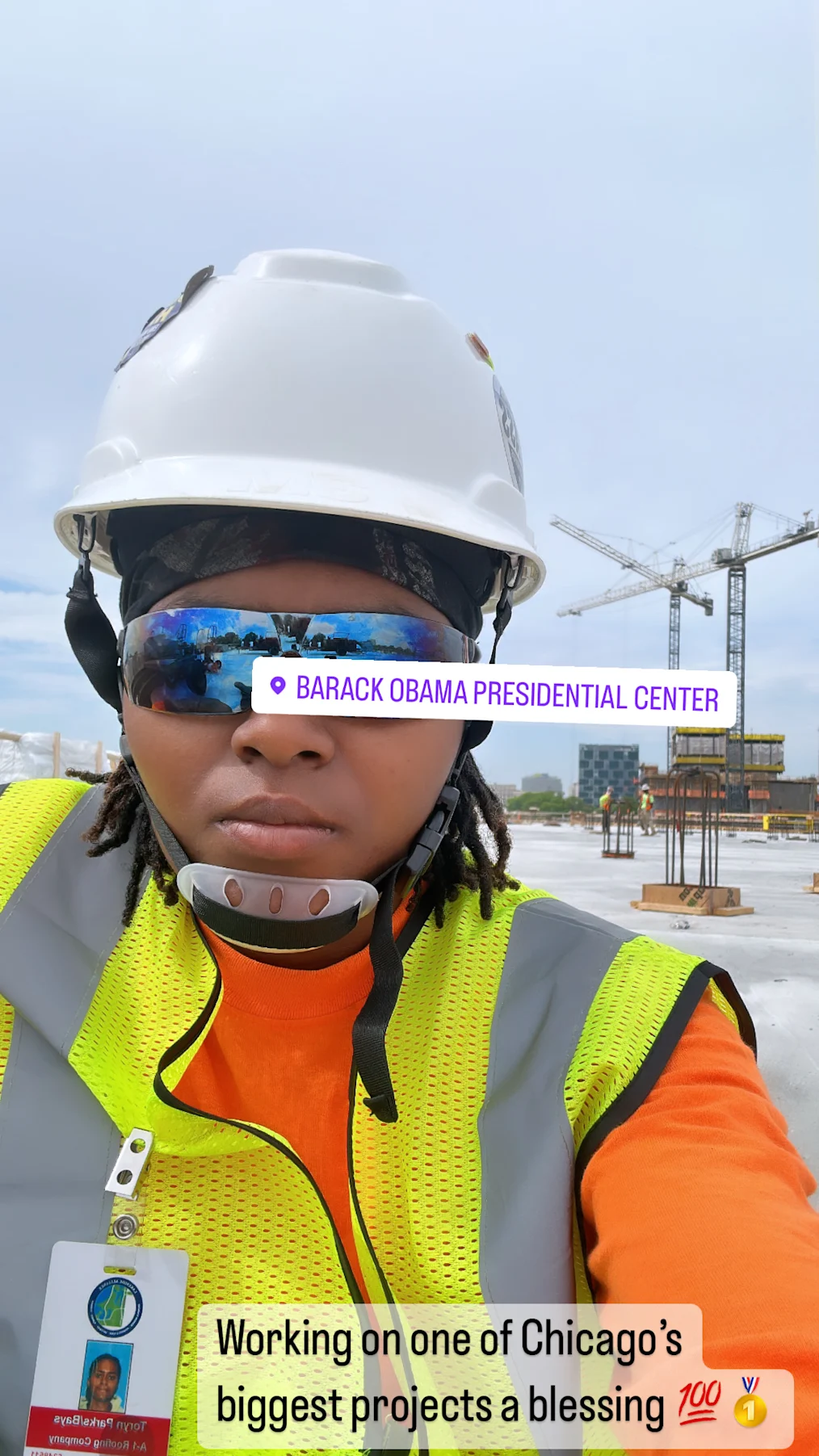 Toryn Parks, a Black woman with a medium skin tone and locs, takes a selfie in her protective gear at the Obama Presidential Center.