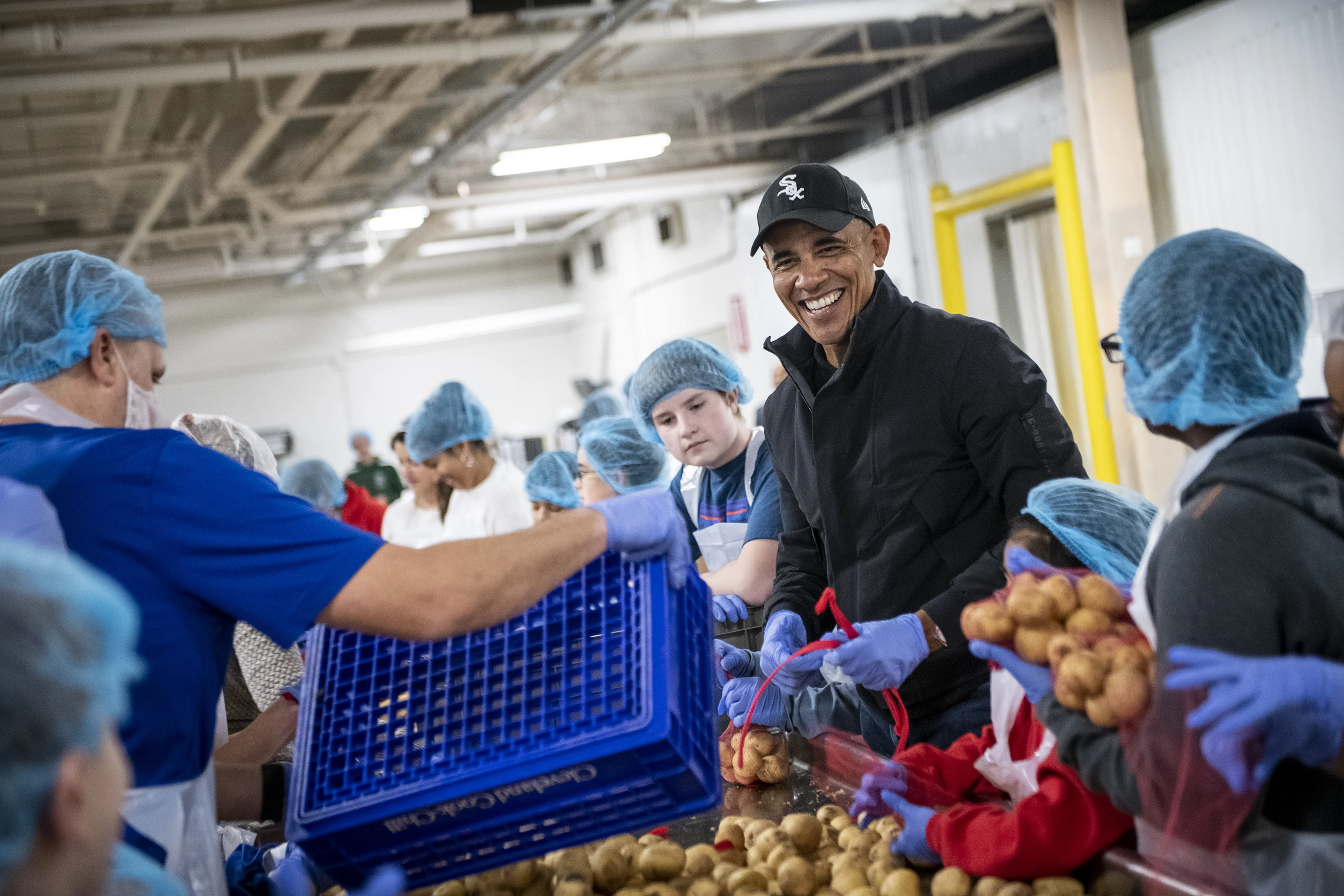 President Barack Obama participates in a service project at the Greater Chicago Food Depository in Chicago, IL