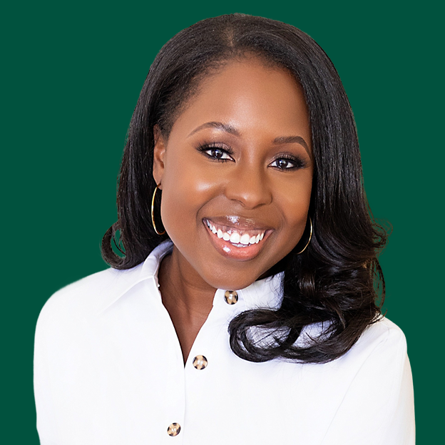 The image is a headshot of Carlisha Williams Bradley. Carlisha has a medium deep skin tone, brown eyes, and black straight hair that falls past her shoulders. She is wearing silver hoop earrings and a white collared shirt with three buttons going down the front. The background of her photo is the color green.