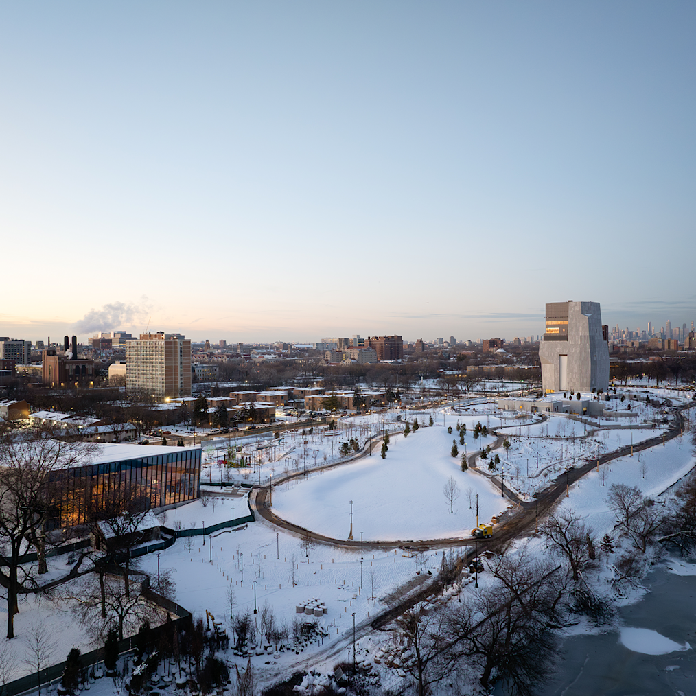 A wide shot of the Great Lawn at the Obama Presidential Center on a snowy day. The Museum Building is in the background. 