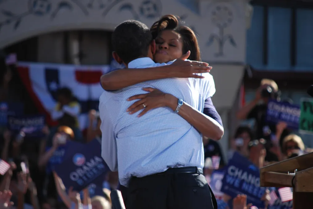 Barack and Michelle Obama hug onstage in November 2008.