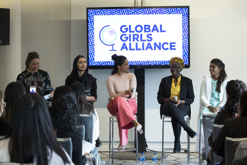 Global girls alliance event with a diverse group of women sitting in chairs 