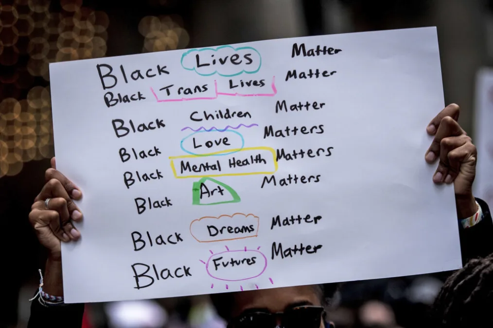 A sign reads Black Lives Matter for different marginalized groups.