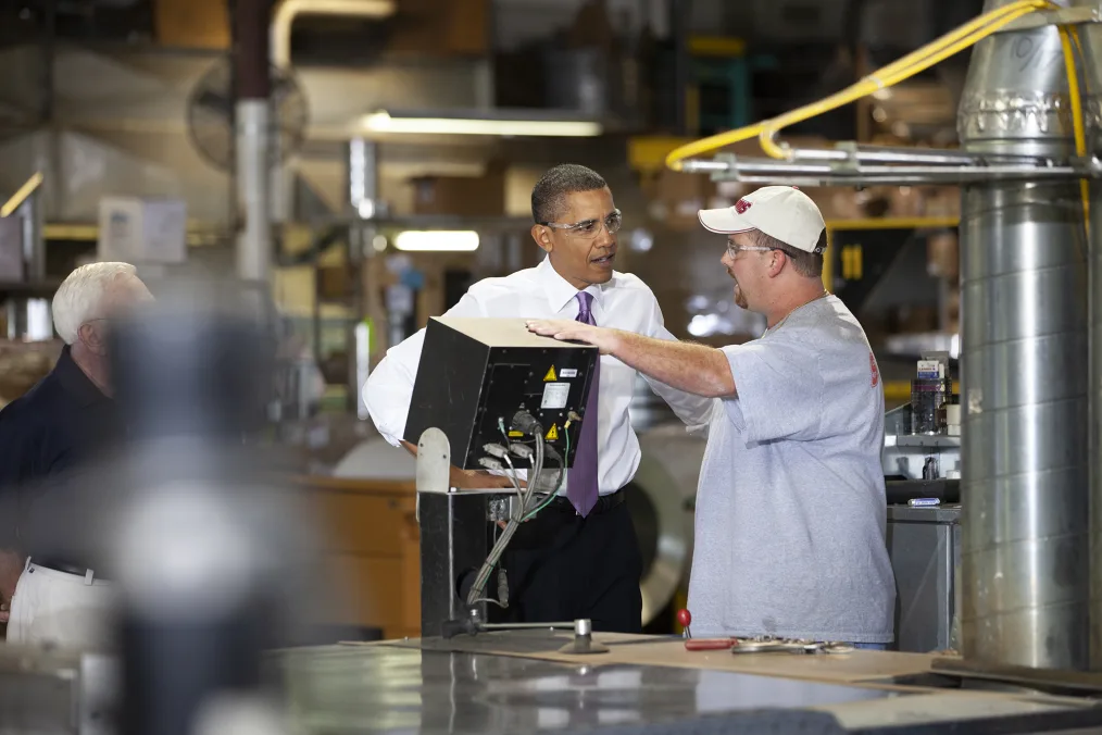 President Obama talks to a factory worker.