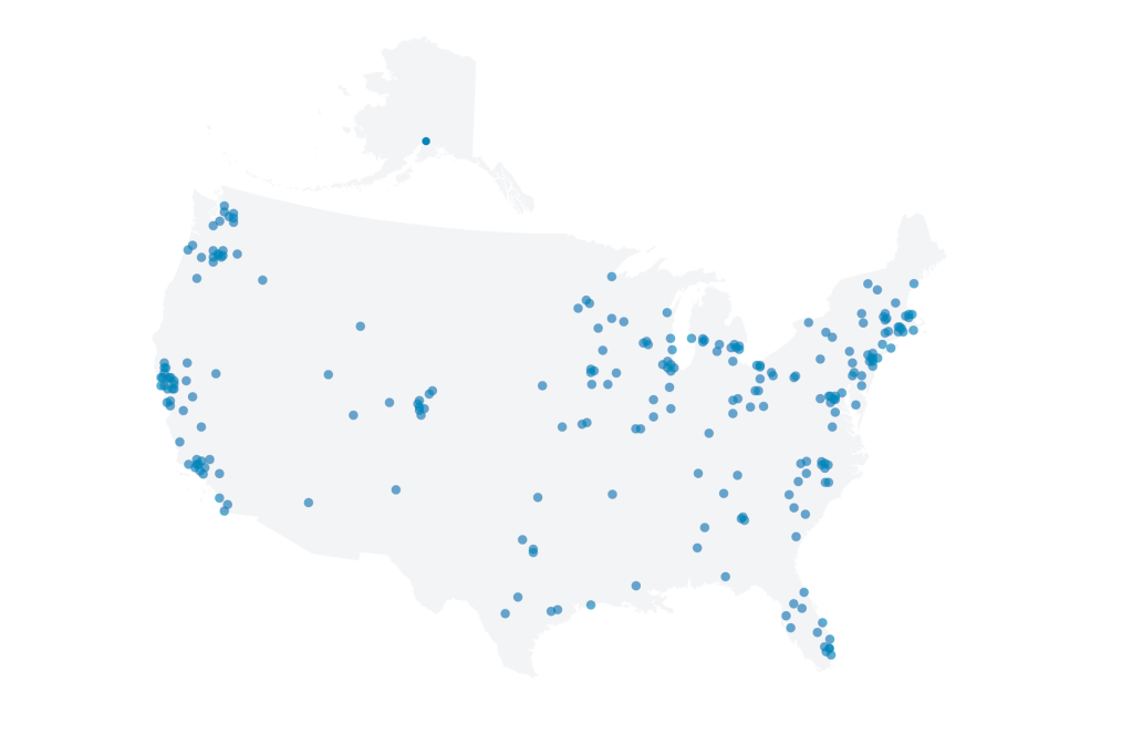 A white map of the United States with small blue dots on it.