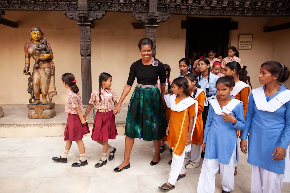 First Lady Michelle Obama, accompanied by a group zof children with a range of light and medium skin tones, tours the National Craft Museum in New Delhi, India, Nov. 8, 2010. (Official White House Photo by Chuck Kennedy)
