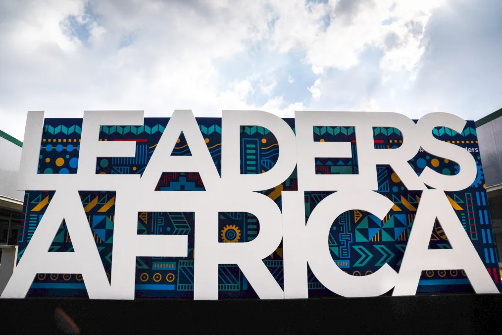 An installation is shown that reads Leaders: Africa in front of a multicolor background with the sky showing in the distance.