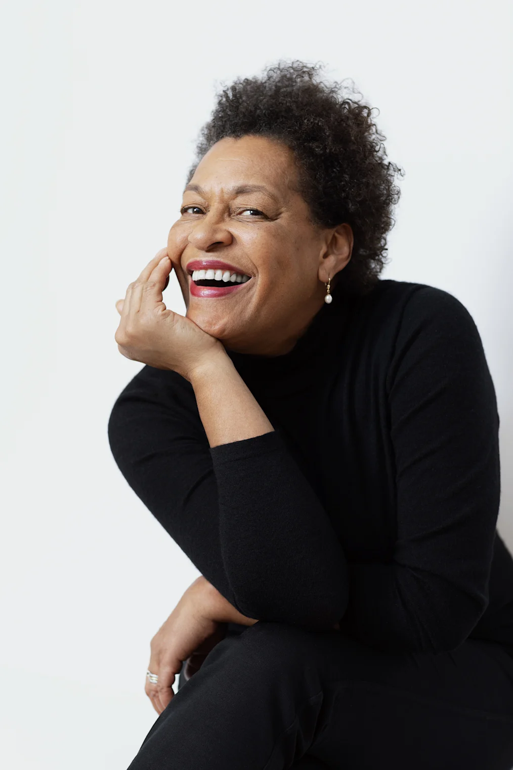 Carrie Mae Weems is sitting down with her right hand holding up her head. Her face is tilted upward and she is smiling at the camera. Carrie has a light-deep skin tone and short curly hair. She has on drop earrings with a pearl at the end. She is wearing a black turtleneck top and dark pants.​​​​‌﻿‍﻿​‍​‍‌‍﻿﻿‌﻿​‍‌‍‍‌‌‍‌﻿‌‍‍‌‌‍﻿‍​‍​‍​﻿‍‍​‍​‍‌‍​﻿‌‍﻿﻿‌‍﻿‍‌﻿‌​‌‍‌‌‌‍﻿‍‌﻿‌​‌‍‌‍‌﻿‌‌‌‍﻿​​‍﻿‍‌‍​﻿‌‍﻿﻿‌‍﻿‌​‍​‍​‍﻿​​‍​‍‌‍‍​‌﻿​‍‌‍‌‌‌‍‌‍​‍​‍​﻿‍‍​‍​‍‌‍‍​‌﻿‌​‌﻿‌​‌﻿​​‌﻿​﻿​﻿‍‍​‍﻿﻿​‍﻿﻿‌‍​‌‌﻿​​‌﻿​​​‍﻿‍‌‍​﻿‌‍﻿﻿‌‍﻿‍‌﻿‌​‌‍‌‌‌‍﻿‍‌﻿‌​‌‍‌‍‌﻿‌‌‌‍﻿​​‍﻿‍‌‍​﻿‌‍﻿﻿‌‍﻿‌​‍﻿﻿‌﻿​﻿‌﻿​​‌‍​‌‌‍​﻿‌‍‌‌‌﻿​﻿​‍﻿﻿‌‍﻿​​﻿‌﻿‌‍‍​​﻿‌‌​﻿‍‌‌‍‍​‌‍‌‍‌‍﻿‍‌‍﻿​‌﻿‍​‌‍‍‍‌﻿‍​​‍﻿﻿‌‍‌‌‌‍﻿‍‌﻿‌‍‌‍‍‌‌﻿​‍‌‍﻿﻿‌‍﻿‍‌‍﻿‌‌‍‌‌‌‍﻿‍‌﻿‌​‌﻿​﻿​‍﻿﻿‌‍﻿‌‌‍​‌‌﻿​﻿‌﻿‌​‌‍‌‌‌﻿​‍​‍﻿﻿‌‍‌‌‌‍﻿‍‌﻿‌​‌﻿​‍‌‍‍‌‌‍‌‌‌﻿​﻿​‍﻿﻿​﻿‌﻿‌​​﻿​﻿​‌‌‍﻿​‌‍‌​‌‌​​‌‍﻿‍‌‍​‌​﻿‍‌‌‌​﻿‌﻿​‍​﻿‍​‌​​‌​﻿‍​‌‌‌﻿‌‌​​‌‍‍‍‌​​‌​﻿‍‌‌​‌​‌‍‍﻿‌‌‍‌​‍﻿﻿​﻿﻿﻿‌‍‌‍‌‍﻿﻿‌‍​﻿‌﻿‌‌‌﻿​﻿‌‍‌‌‌‍‌​‌​‌‍‌‍‍‌‌‍‌‌‌‍﻿​‌‍‌​​﻿﻿‌‌‍​‌‌‍﻿​‌﻿‌​‌‌‌​‌‍‌‌‌﻿‍​‌﻿‌​​‍‌‍‌‍‌‍‌‍﻿﻿‌‍​﻿‌﻿‌‌‌﻿​﻿‌‍‌‌‌‍‌​‌​﻿​‌‍﻿﻿‌‍​﻿‌‍​‌‌‍﻿​‌‍‌‌​﻿﻿‌‌‍‌‌‌‍﻿‍​‍﻿‌‌‌‌‌‌‌​﻿​‍‌‍‌﻿​﻿‌‍﻿﻿‌﻿‌‌‌﻿​‍‌‍​﻿‌‍‌‌​﻿﻿‌‌﻿‌‍‌‍‌‌‌﻿​‍‌‍​﻿‌‍‌‌‌‍﻿​​‍﻿‌‌‍​﻿‌‍﻿﻿‌‍﻿‍‌﻿‌​‌‍‌‌‌‍﻿‍‌﻿‌​​‍﻿‌‌‍﻿​‌‍‍‌‌‍﻿‍‌‍‍﻿​‍​‍​‍﻿​​‍​‍‌‍​﻿‌‍﻿﻿‌‍﻿‍‌﻿‌​‌‍‌‌‌‍﻿‍‌﻿‌​‌‍‌‍‌﻿‌‌‌‍﻿​​‍​‍​﻿‍‍‌﻿‍﻿​‍​‍‌‍‌‌‌‍‌​‌‍‍‌‌﻿‌​‌‍﻿﻿‌﻿​‍‌​‍‌‌‍﻿‍‌﻿‌​‌‍‌‌‌﻿​‍‌‍‌‍‌‍​‌‌‍​﻿‌‍‌‌​‍​‍​﻿‍‍‌﻿‍﻿​‍​‍‌﻿‌﻿‌‍‍‌‌‍‌​‌‍‌﻿‌‍‌‌‌﻿‌​‌​‍‌‌‍‌​​‍​‍​﻿‍‍​‍​‍‌‍﻿‌‌﻿‌‌‌‍﻿​‌﻿‌​‌‍‍‌‌﻿​​‌‍﻿​‌‍‌‌‌​﻿​‌‍‍‌‌‍﻿‍‌‍‌‌​‍​‍​‍﻿​​‍​‍‌﻿‌﻿‌‍‍‌‌‍‌​‌‍‌﻿‌‍‌‌‌﻿‌​‌​﻿‍‌‍​‌‌‍﻿‌‌‍‌‌‌﻿​﻿‌﻿​​‌‍​‌‌‍​﻿‌‍‌‌​‍​‍​﻿‍‍​‍​‍‌‍​‍‌﻿‌‌‌‍‍‌‌‍﻿​‌﻿‌​‌‍‍‌‌‍﻿‍​‍​‍‌﻿﻿‌​‍﻿​​‍​‍‌‍‌‍‌‍‍‌‌‍‌‌‌‍﻿​‌‍‌​‌‌‌​‌﻿‍‌‌﻿​​‌‍‌‌​‍​‍​﻿‍‍​‍​‍‌‌‌​‌‍‌‌‌﻿‍​‌﻿‌​​‍​‍‌﻿﻿‌‌﻿﻿‌
