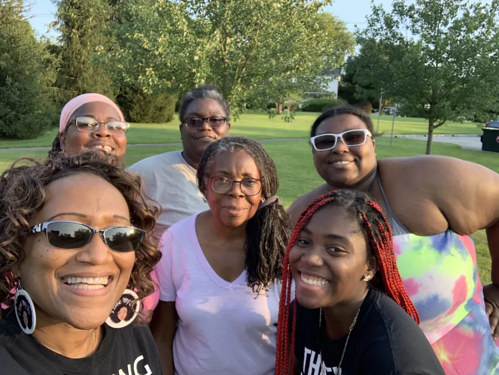 A group of women smile to camera.