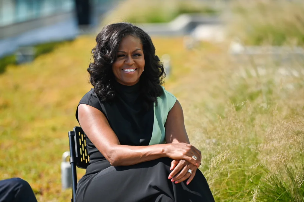 Mrs. Obama smiling during the scholar conversation with President Obama.