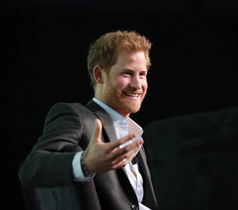 Prince Harry smiles with his hand outstretched during the Obama Foundation Summit.