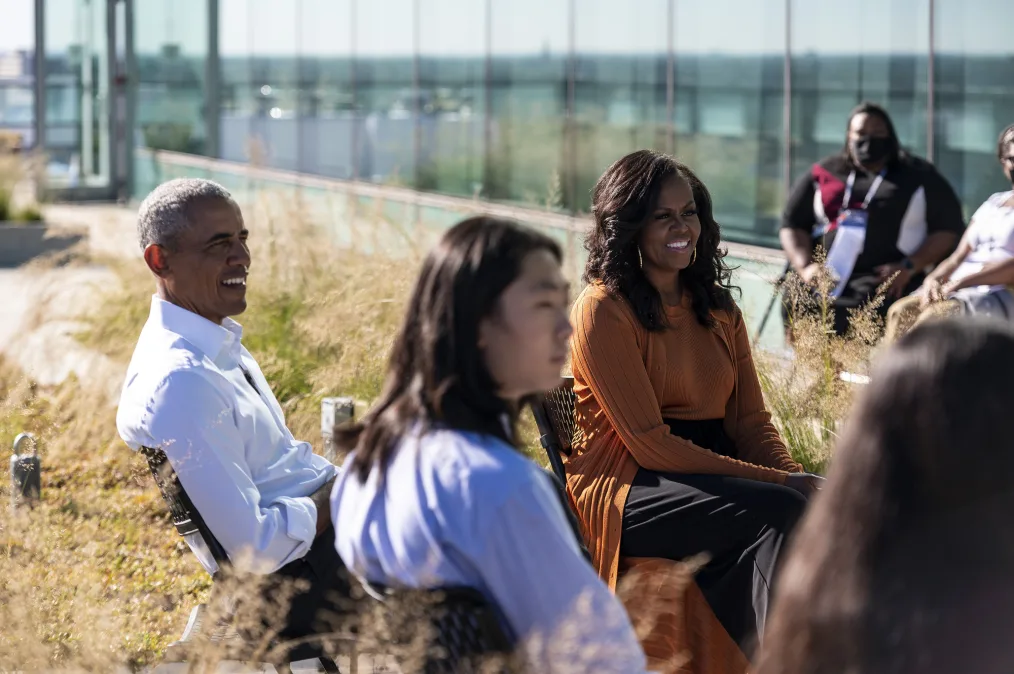 President and Mrs. Obama sitting and listening to Chicago Public School students