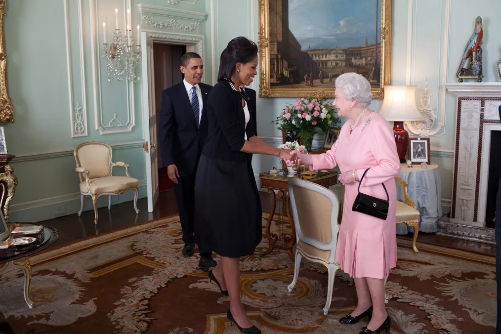 President Barack Obama and First Lady Michelle Obama shake hands with Queen Elizabeth. 