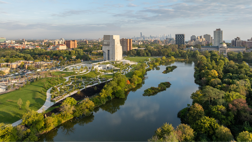 On a bright day, the Obama Presidential Center campus is seen facing south in Chicago in September 2025. The Columbia Basin, Wooded Island, Jackson Park Lagoon Loop is in the foreground and the Obama Presidential Center is in the background. (Credit: Angie McMongial)