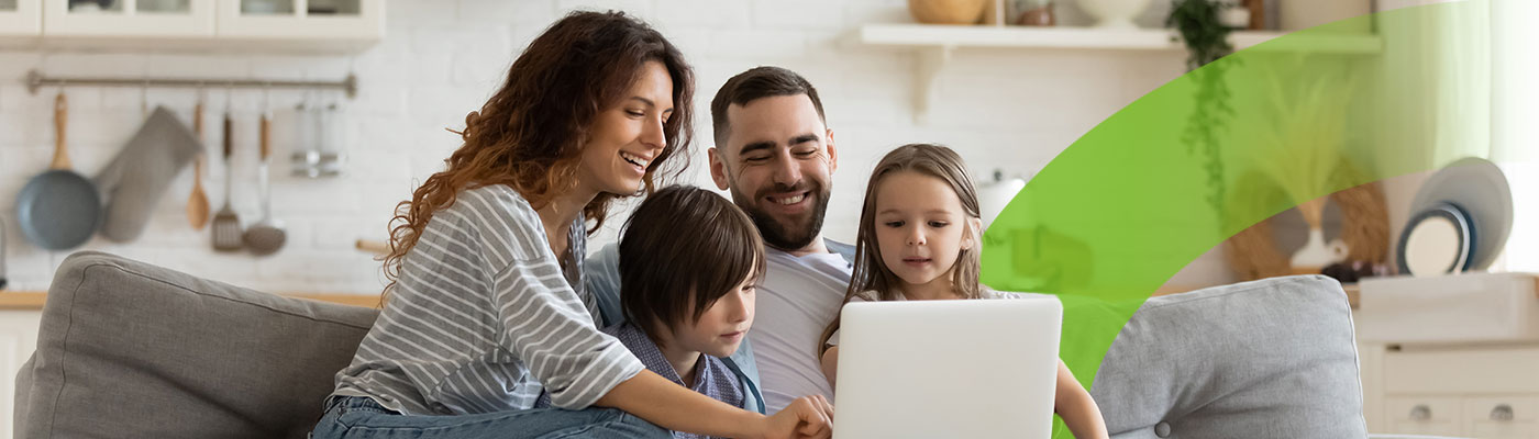 Picture of a family looking at a laptop.