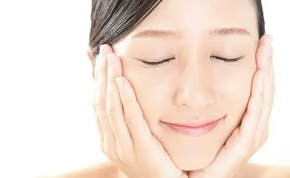 Young woman enjoying smooth facial skin
