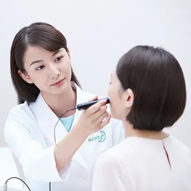 Female dermatologist checking on facial skin