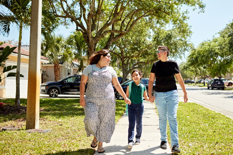 Three people in a neighborhood