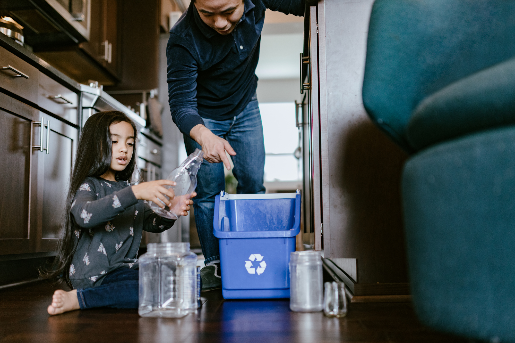 A man and girl recycle