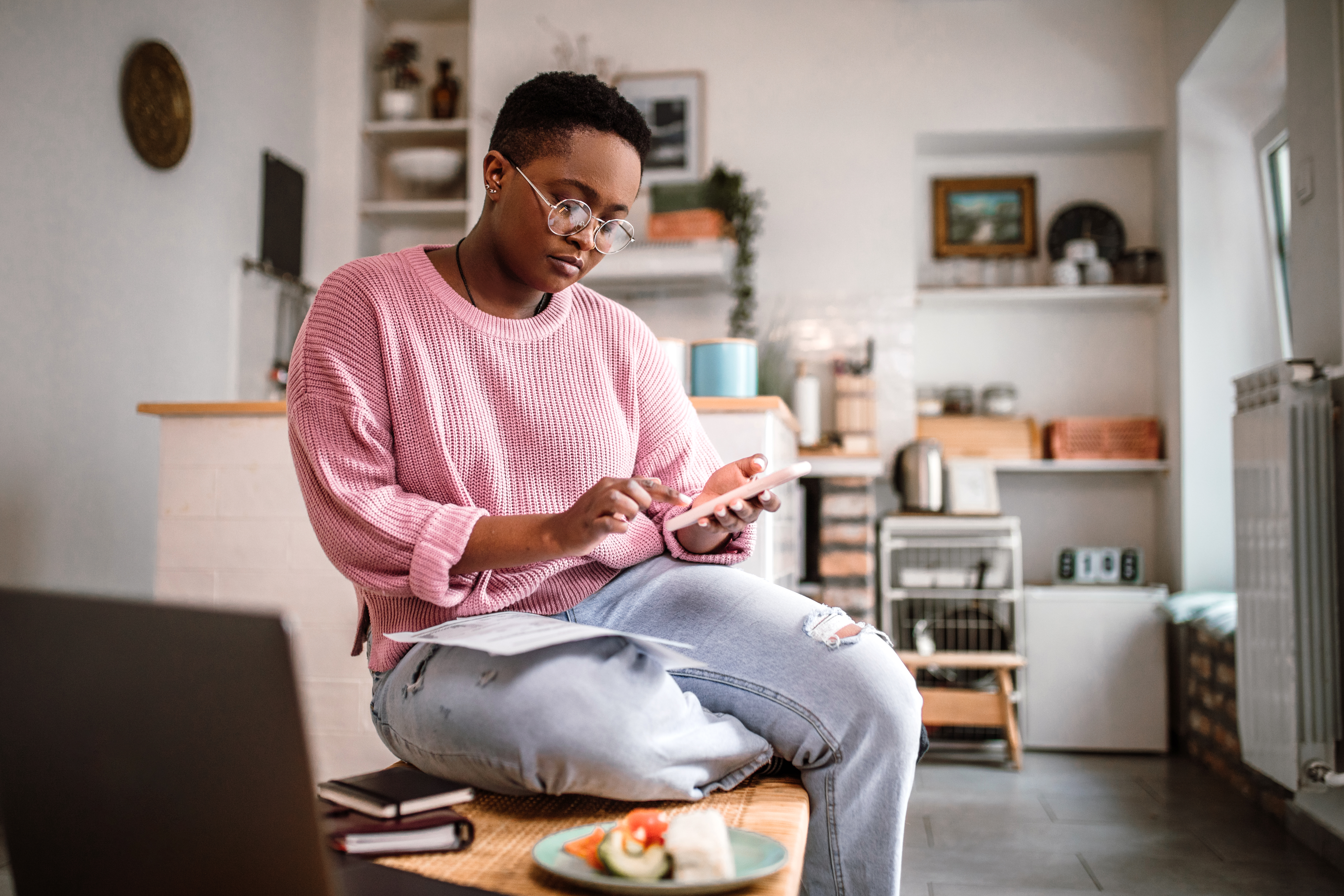 A woman using a phone and computer