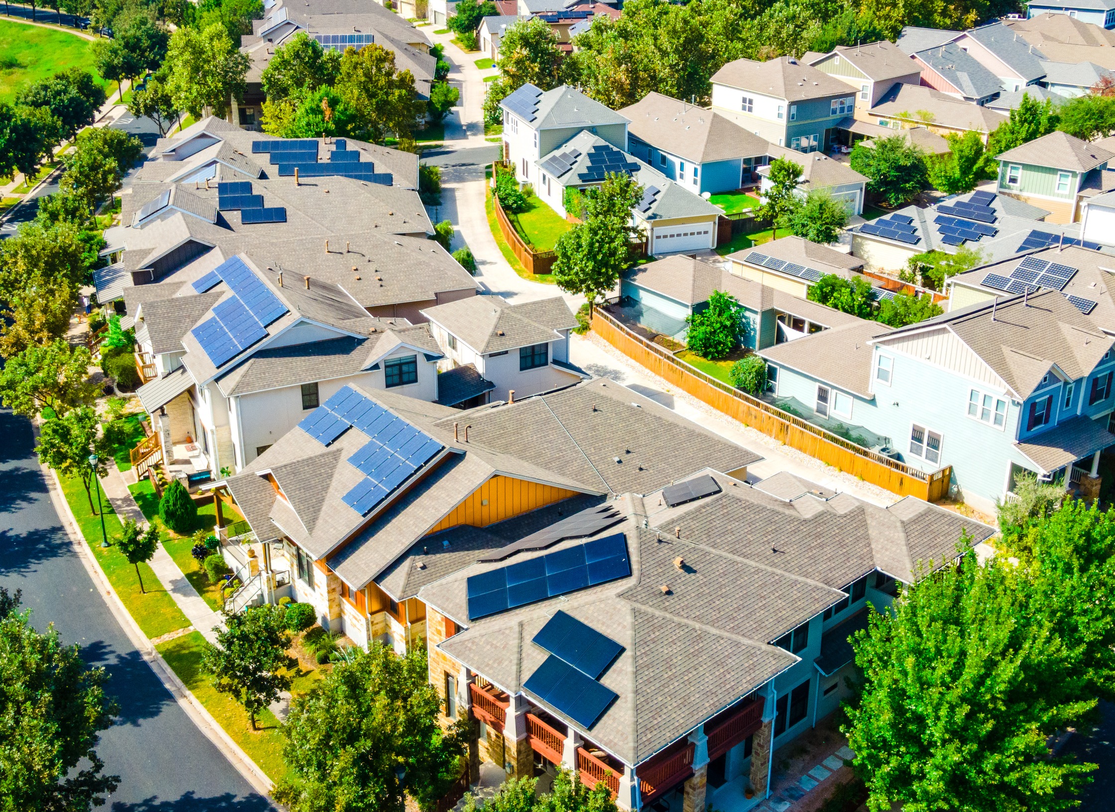 solar panels on the roofs of houses in a neighborhood