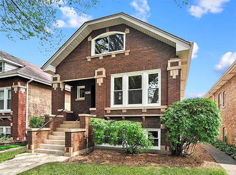 Chicago brick rental home with stairs up to a covered front porch.