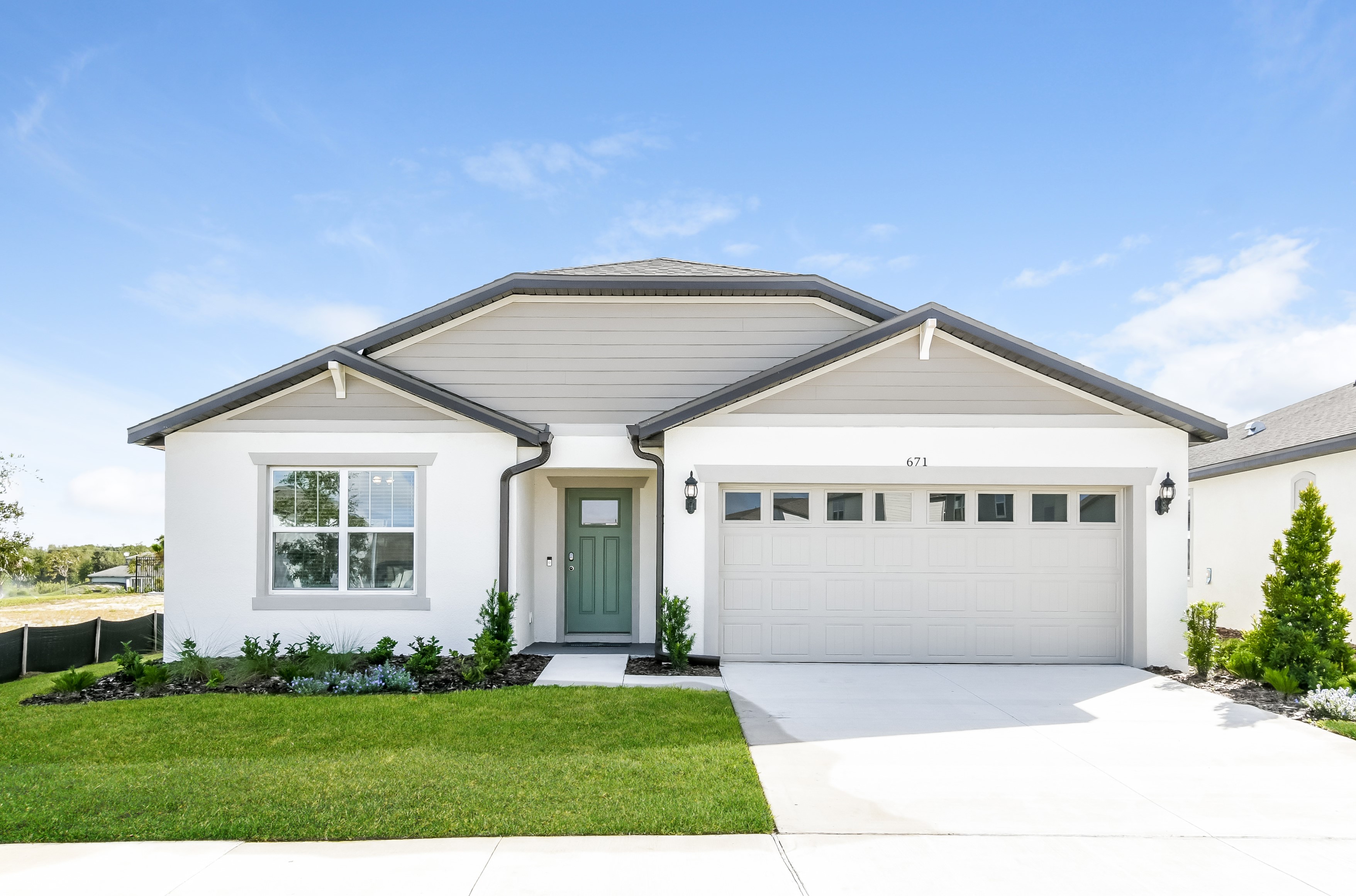 Silverlake rental community front of home shot with a two-car garage and green front door.