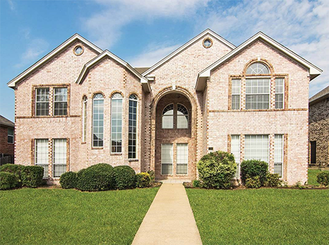 Dallas large rental home with a covered porch and lots of large windows.