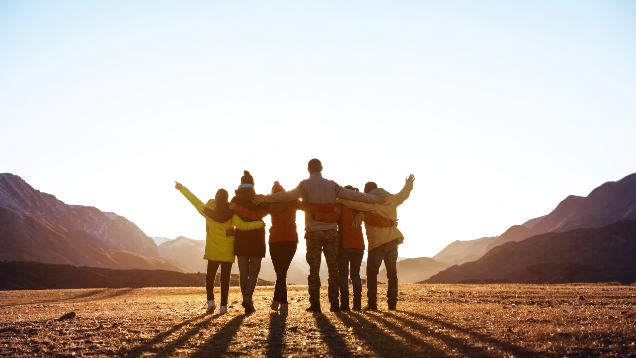 https:A photo showcasing diverse people using a map to plan a group adventure trip.