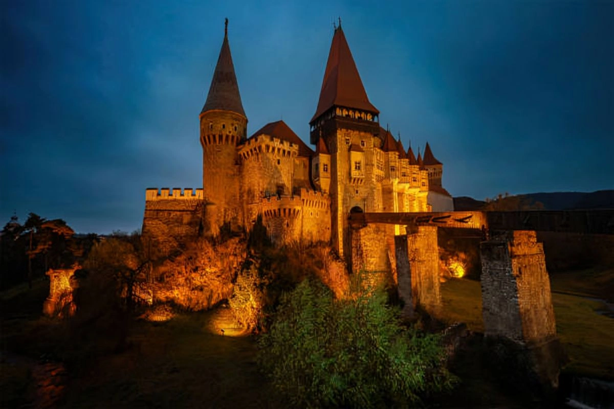 https:A striking nighttime image of Bran Castle, or Dracula’s Castle, shows its gothic towers lit up against a pitch-black sky. The castle’s dramatic setting and spooky charm draw millions of visitors to Transylvania every year.