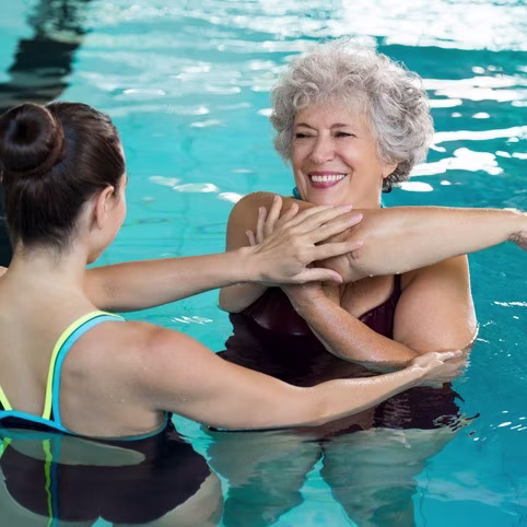 Senior woman stretching in poo