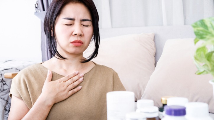 Allergic reaction to medication with symptoms of respiratory distress and nausea in a woman 