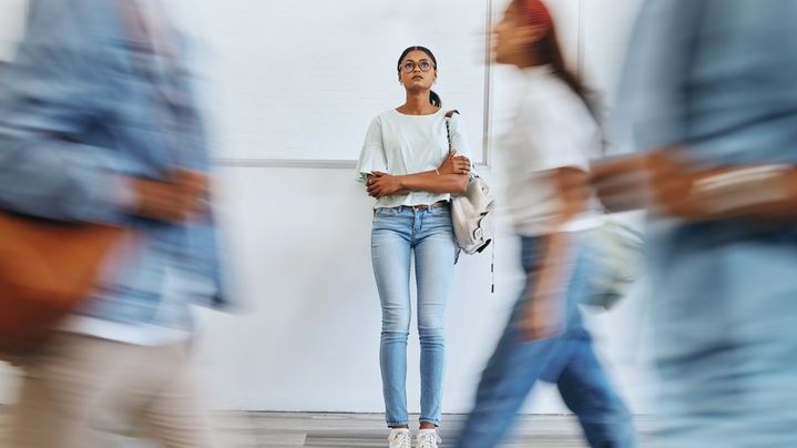 Student, anxiety and woman in busy college campus 